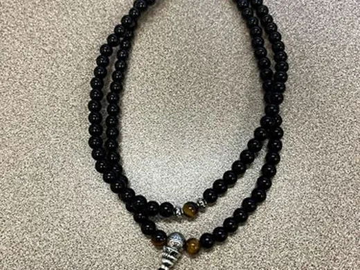 108 bead mala necklace laid out flat
