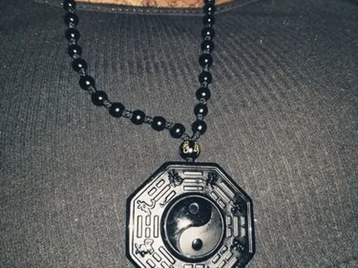 Customer wearing a black obsidian pendant necklace