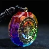 Chakra orgonite pendant close-up with gold Sri Yantra symbol on rainbow resin
