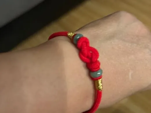 Customer wearing a hand-knotted red string bracelet