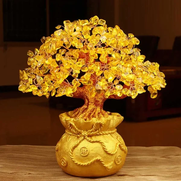 Citrine crystal money tree with a golden money bag pot on a wooden table