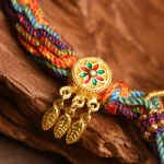 Close-up of the enamel prayer wheel and feather charms