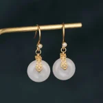 Gold double happiness drop earrings with white jade discs
