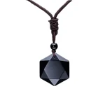 Faceted black obsidian pendant on a brown cord, white background