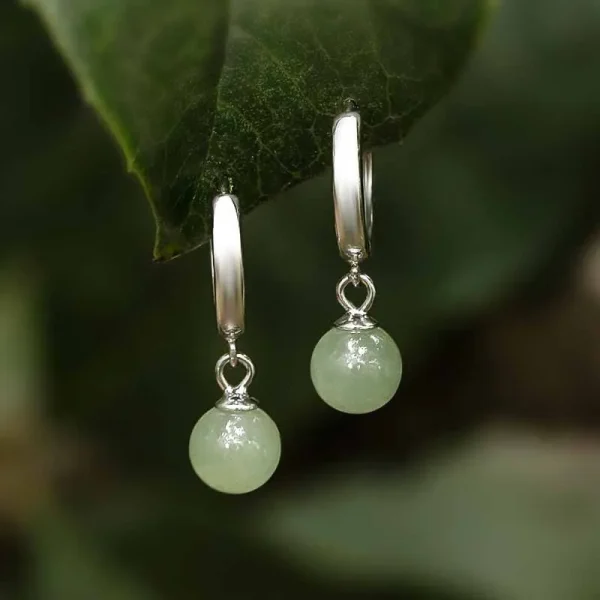 Silver hoop earrings with green jade bead pendants