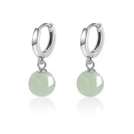 Silver huggie earrings with green jade bead drops on white