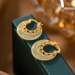 Gold openwork crescent hoop earrings with green jade