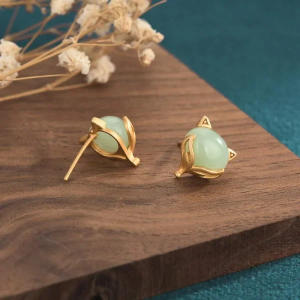 Green jade fox stud earrings showing the ear post
