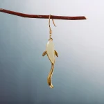 Koi fish jade earring hanging on a branch