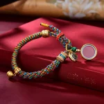 Multicolored Tibetan bracelet with a round ghau prayer box pendant
