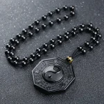 Black obsidian bagua pendant on a black bead necklace