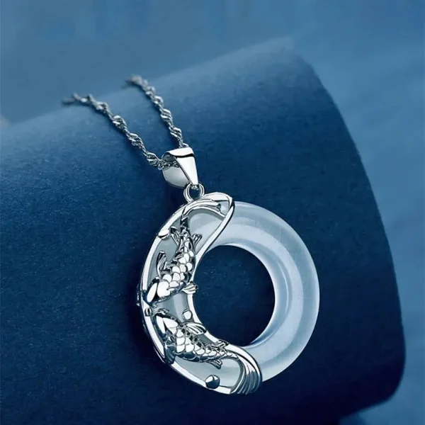 Close-up of jade koi fish pendant, sterling silver necklace detail, lucky symbol